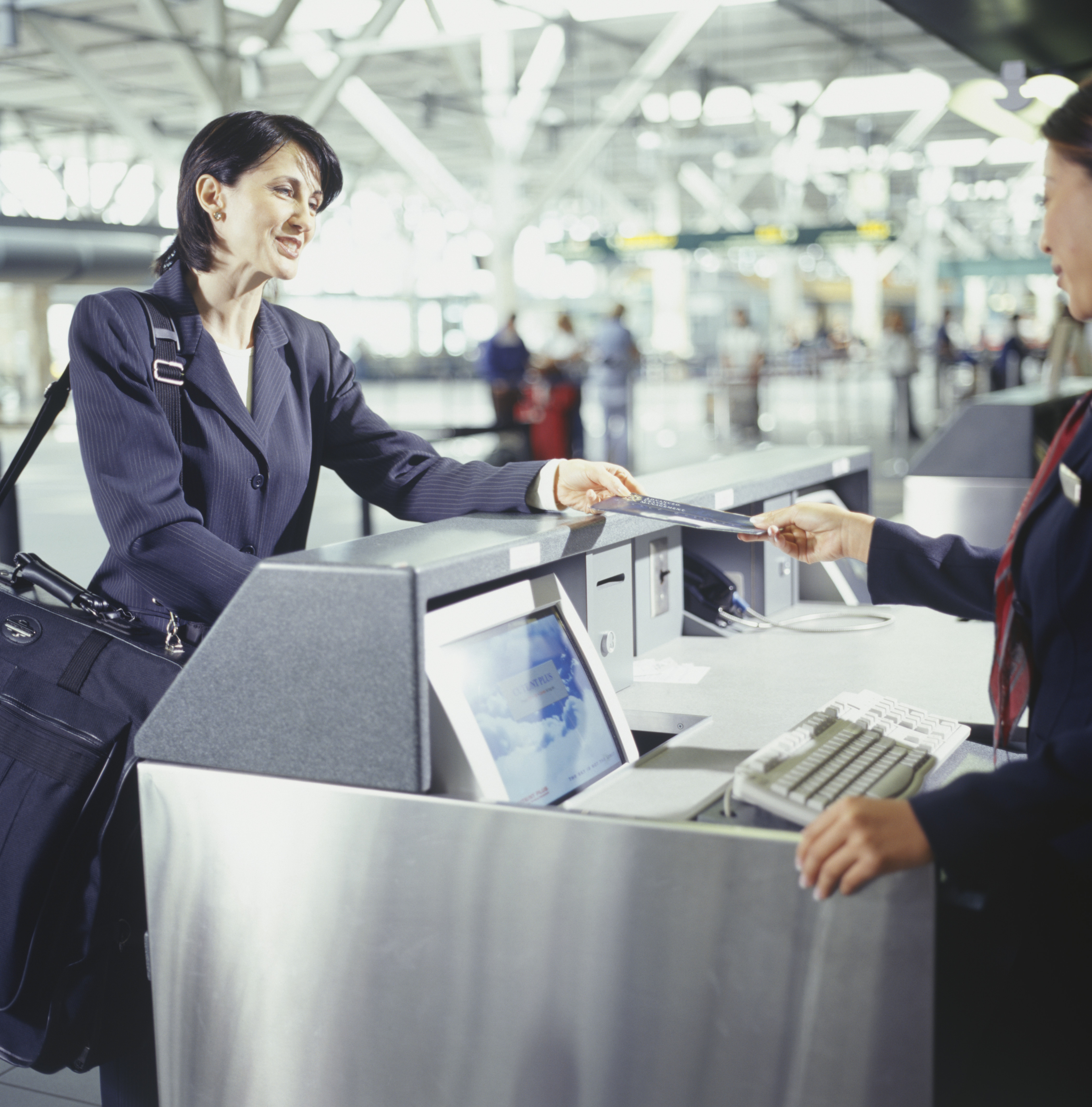 Businesswoman at airport ticketing counter
