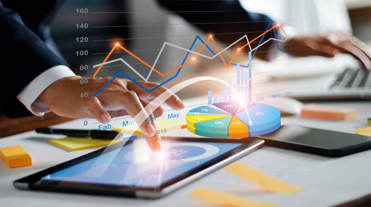 Businessman using tablet and laptop analyzing sales data and economic growth graph chart. Business strategy. Digital marketing. Business innovation technology concept