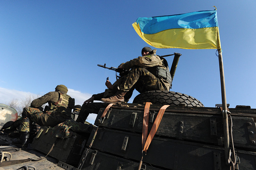 SOLEDAR, UKRAINE - FEBRUARY 27: Soldiers in the Ukrainian Army withdraw 15, 100 mm caliber artillery guns in Soledar, eastern Ukraine, on February 27, 2015. In accordance with a February 12 ceasefire brokered by the leaders of Ukraine, Russia, Germany and France, Ukrainian forces and Russia-backed separatists agreed to stop fighting and withdraw heavy weapons from the frontlines of a conflict that has killed over 5,000 people in the past year. (Photo by Scott Peterson/Getty Images)