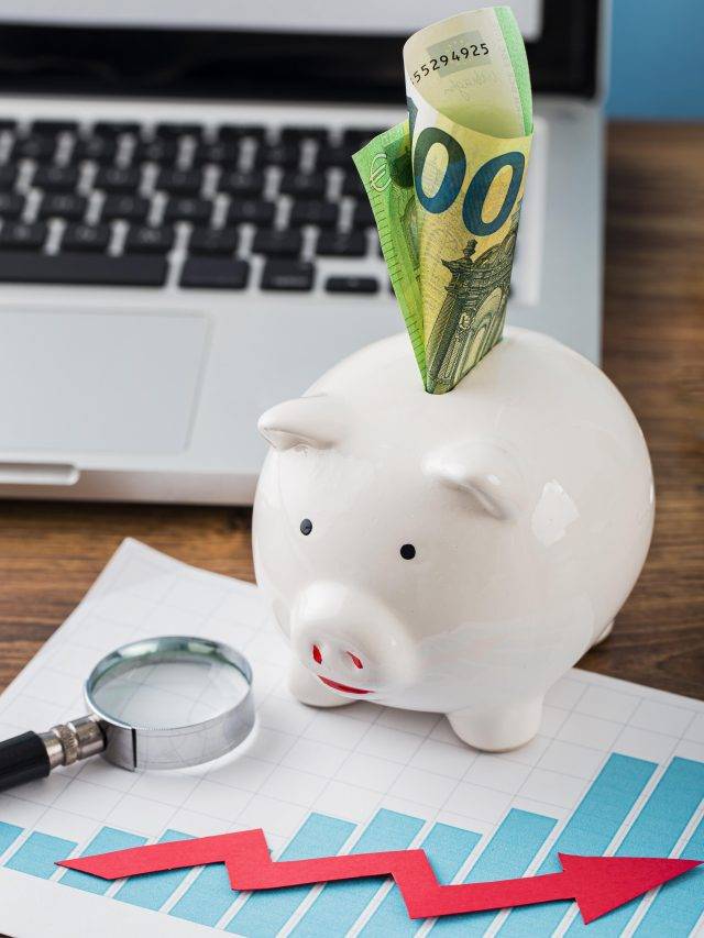high-angle-office-items-with-piggy-bank-growth-chart