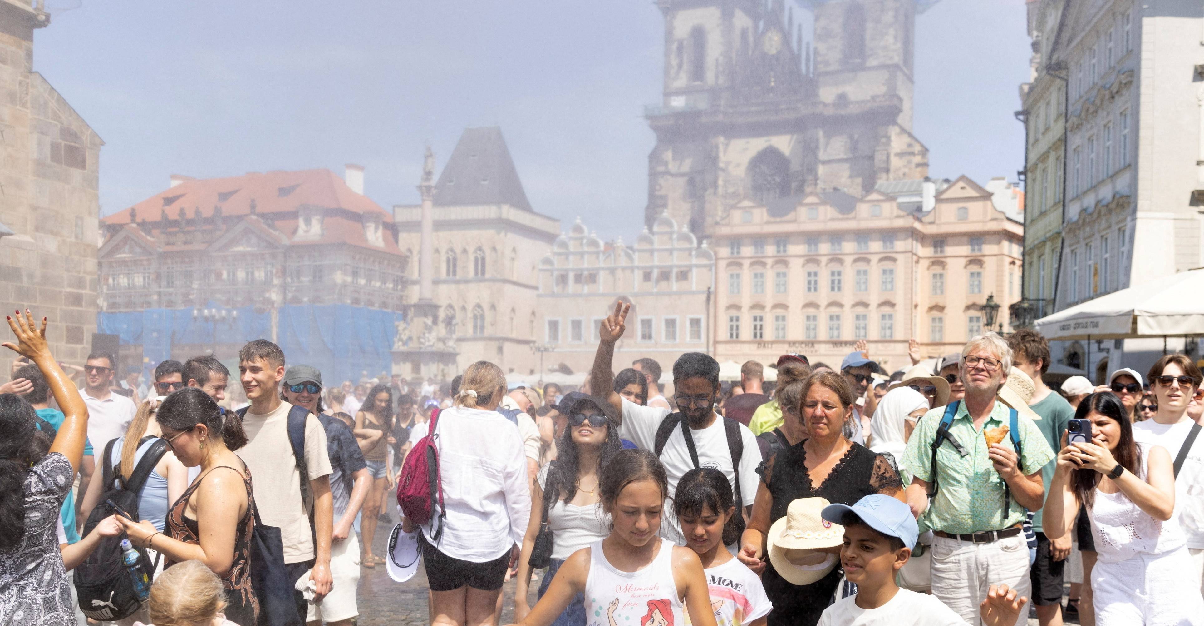 Pessoas são borrifadas com água para se refrescarem durante um dia quente e ensolarado em Praga
28 de junho de 2026 REUTERS/Eva Korinkova