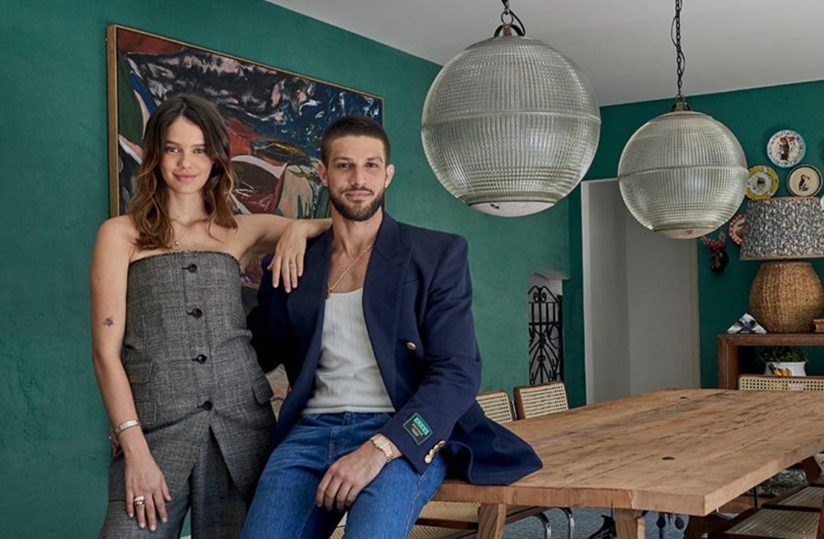 Chay Suede e esposa Laura Neiva na sala de sua mansão